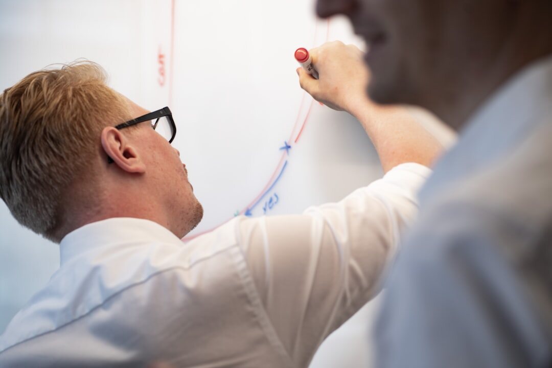 Business professionals analyzing a growth chart on a large screen